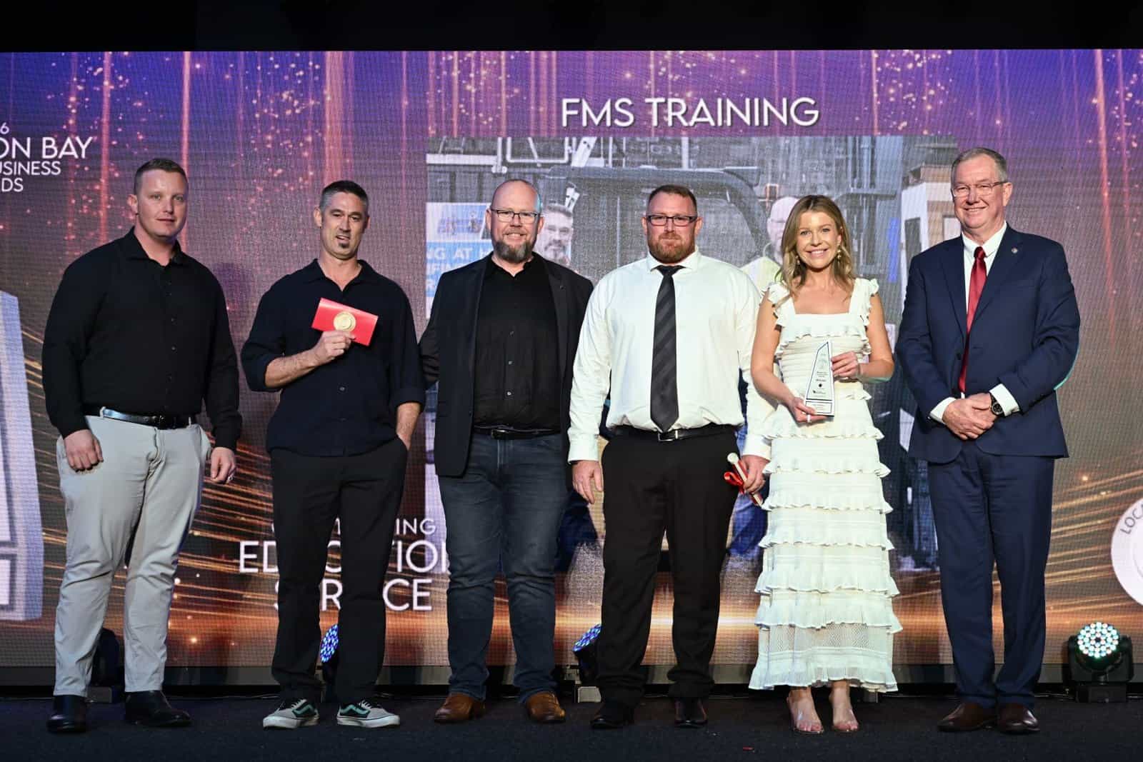 The FMS Training team accepting the Outstanding Education Service award, 2026